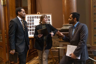 Armando Bryson, Kaylynn Sieverding with Maaz Bin Musa in State Capitol building.