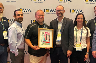 Mike Norris and group from Homes for Iowa receiving award.