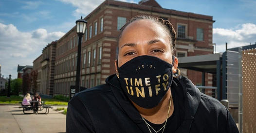 Picture of Raina Harmon wearing a face mask that says, "It's time to unify."