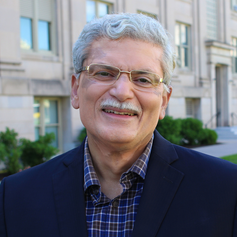 Associate Professor Jerry Anthony standing outside Jessup Hall on the University of Iowa campus