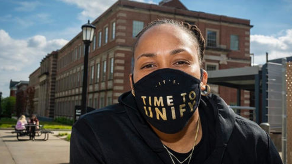 Picture of Raina Harmon wearing a face mask that says, "It's time to unify."